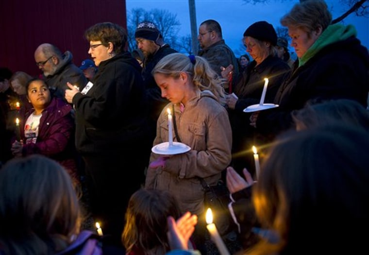 Megan Lehman, center, stands amongst a crowd of over 50 people who gathered Monday night, Dec. 26, 2011, for a candlelight vigil for missing 9-year-old girl Aliahna Lemmon, in Fort Wayne, Ind. Lemmon was last seen Friday, Dec. 23. (AP Photo/The Journal Gazette, Swikar Patel) NEWS-SENTINEL OUT